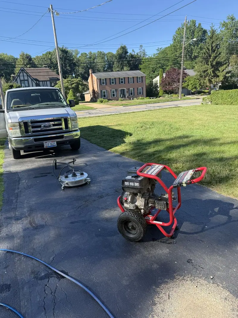 Surface cleaner and pressure washer set up on a driveway